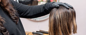 A hairdresser making a wig